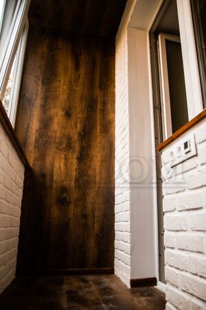 Темный ламинат и декоративный белый кирпич на лоджии - Заказать в Минске отделку балконов